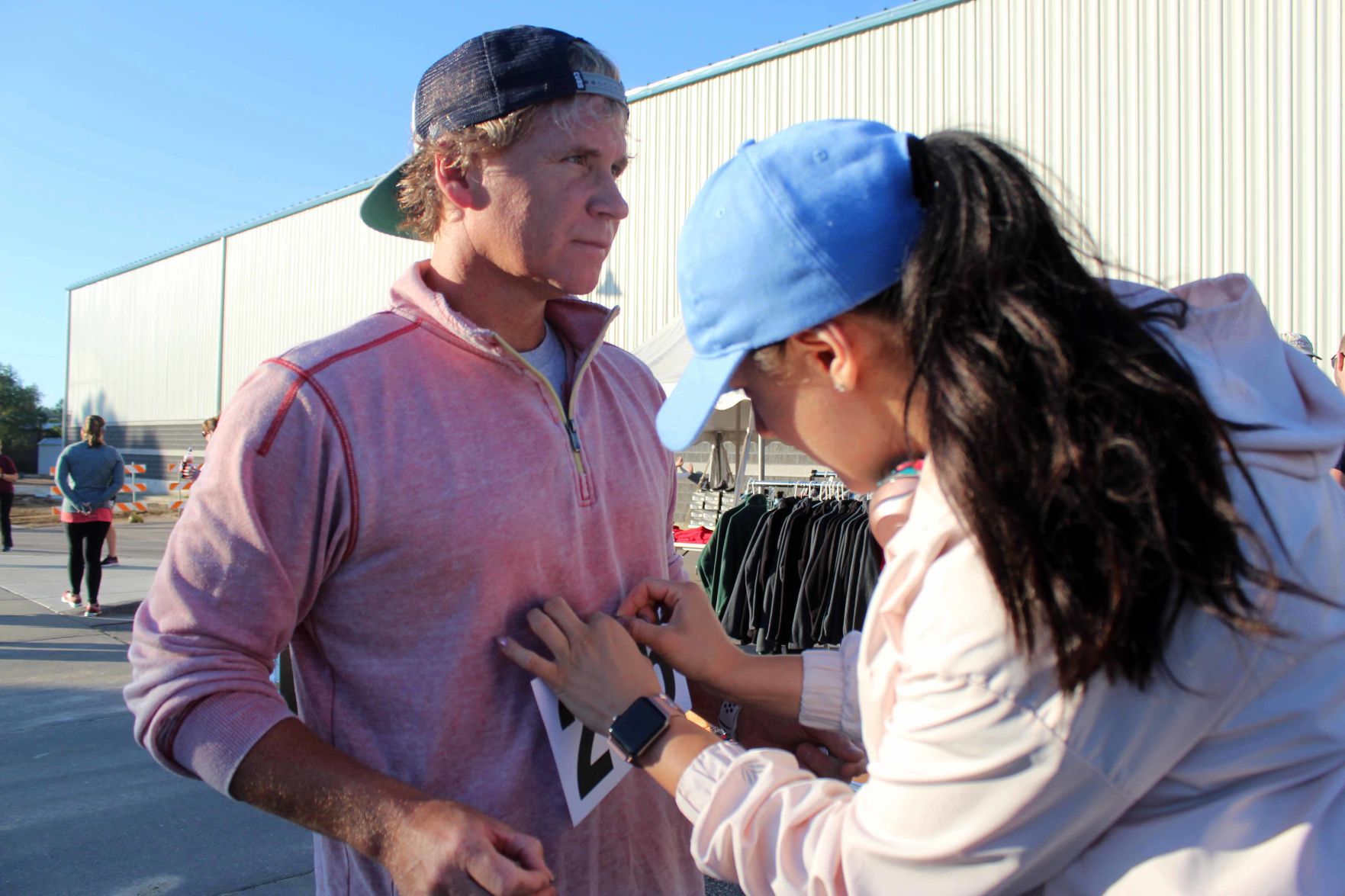Ana helps Jeff with race bib